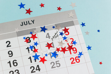 Business calendar marked with the date of July 4th confetti of American national colors. US Independence Day celebration. Selective focus.