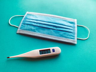 Mask and thermometer in blue background