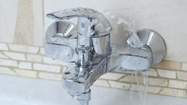 Bathroom leak. Close up  a water leaking tap Faucet,  hous keep work fix leak. Ambient sound 50fps 4K