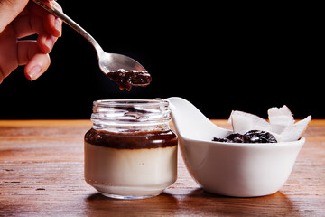 Nutrition concept - Healthy cheese cake in glass jars over wooden background. Healthy food, Diet, Detox, Clean Eating or Vegetarian concept. Delicious dessert option.