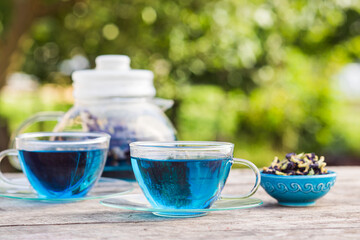 Tea ceremony with blue Thai tea anchan outdoors
