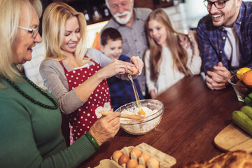 Multi Generation Family Cooking Meal At Home