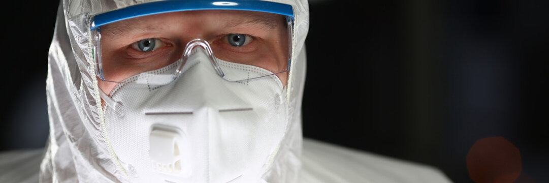 Male Doctor In White Scrubs Portait On Mood Background. Medical Individual Protection Means Concept