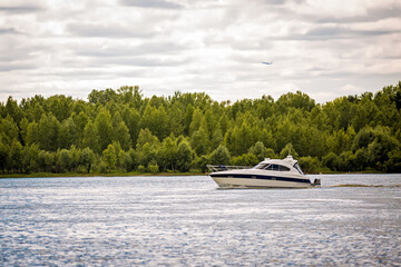 Fototapeta premium yacht is floating on the river. boat in the ocean. ship at sea