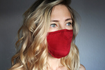 Stylish woman wearing cloth cotton face mask protect against coronavirus.  Reusable fashionable face mask. 