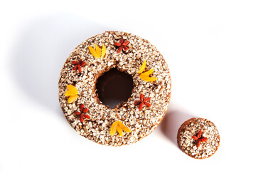 Fruit cake over white background. Traditional homemade Christmas cake with goji berries and Damascus flower decorations. White background.