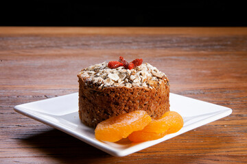 Traditional homemade Christmas cake. Holiday dessert with Damascus and dry goji berry on vintage...