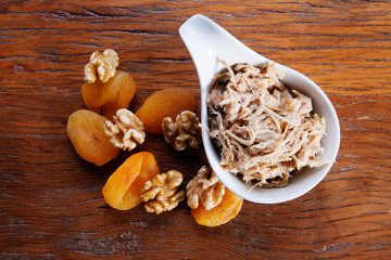 Nutrition concept - Healthy meals made of chicken, nuts and Damascus in bowls over wooden background. Healthy food, Diet, Detox, Clean Eating or Vegetarian concept.