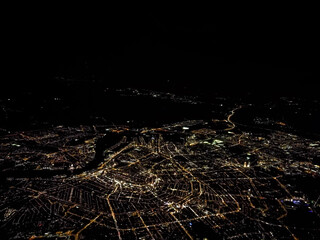 Aerial view of Amsterdam with illuminated streets at night - obrazy, fototapety, plakaty