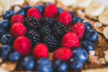 Cereals and fruits superbowl, healthy bowl breakfast with flakes, oat and fruits: strawberries, blueberries, banana, blackberries