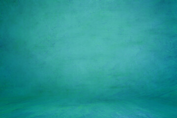 Green aquamarine textured background; embossed photographic studio backdrop. Muslin wall and floor
