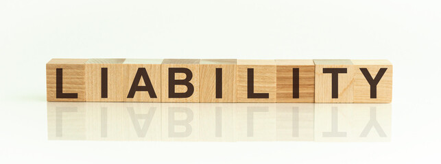 Wooden Blocks with the text: LIABILITY. The text is written in black letters and is reflected in...