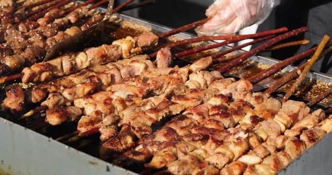 close up people cooking many mutton Shashlik on grill