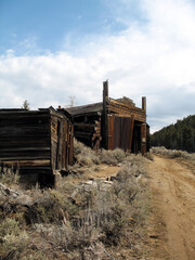 Rustic old ghost town buildings  in a remote western landscape