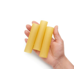 hand holds raw cannelloni pasta of body part isolated on white background