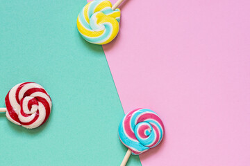 Tasty aromatic lollipops on two tone background top view. copy space for your design. 