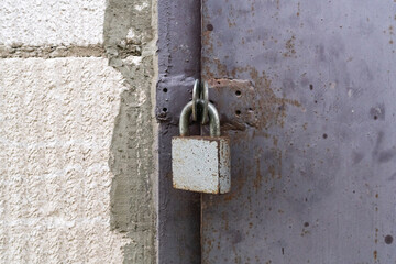 The padlock on the metal door