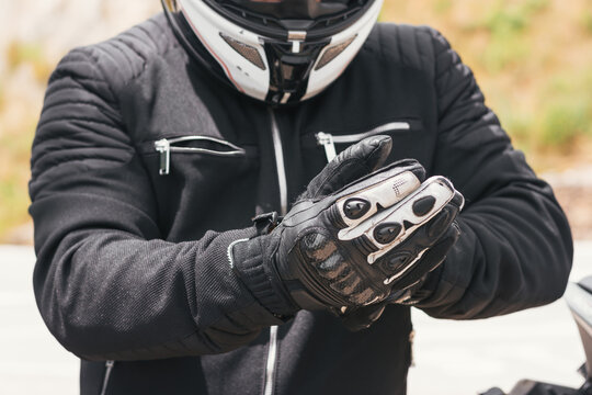 biker puts on his gloves to ride his bike
