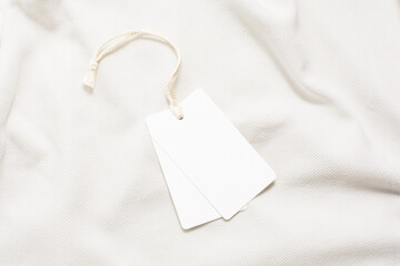 Mockup label tag on white textile background.