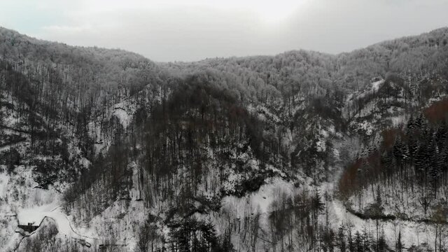 Flying over snowy mountains in Abant National Park, Turkey. Drone footage 4K