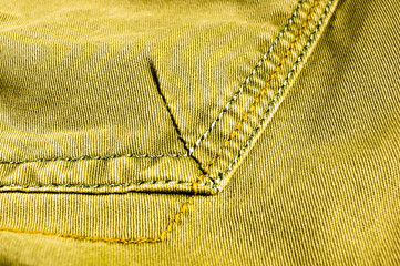 clothing items stonewashed cotton fabric texture with seams, clasps, buttons and rivets, macro