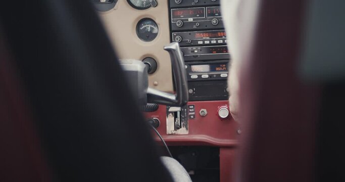Instrumental panel and yoke control wheel hand pilot flying small airplane plane sport aircraft over shoulder instruments close up