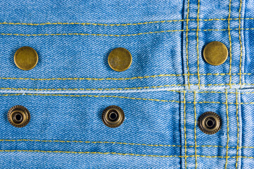 clothing items blue stonewashed faded jeans cotton fabric texture with seams, clasps, buttons and...