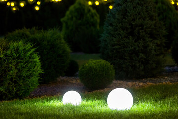 backyard ground 2 light garden with lantern electric lamp with sphere diffuser in green grass with...
