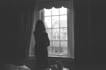 woman looking out the window