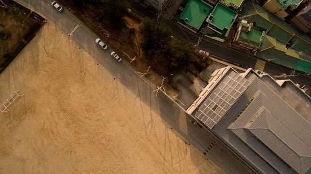 Aerial View Building And Dirt Soccer Field.