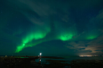 Fototapeta na wymiar Northern Lights at Grótta Island lighthouse near Reykjavik