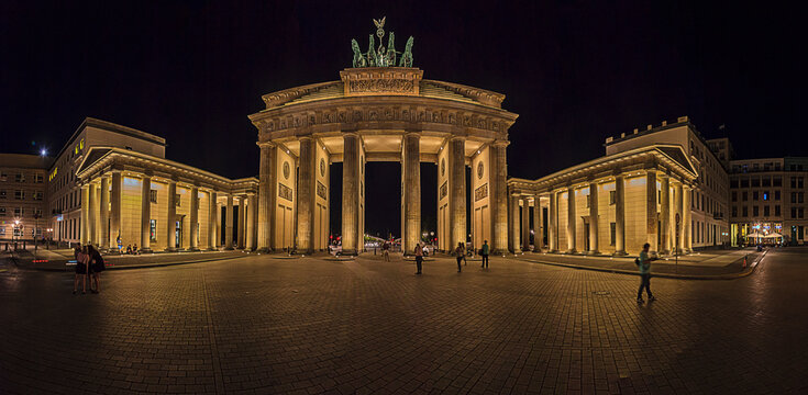 Night view over Paris square to illuminated Brandenburger gate in Berlin in summer