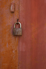 Old rusty lock on a metal garage door