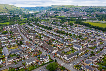 Aerial drone view of a residential area of a small Welsh town surrounded by hills (Ebbw Vale, South Wales, UK)