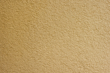 Texture of decorative plaster with a relief. Beige plaster. Close-up.