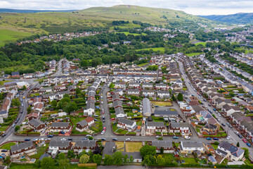 Obraz premium Aerial drone view of a residential area of a small Welsh town surrounded by hills (Ebbw Vale, South Wales, UK)
