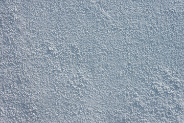Texture of decorative plaster with a relief. White plaster. Close-up.