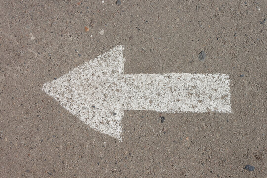 A white arrow is drawn on the asphalt