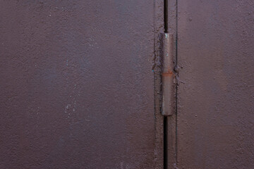 Painted metal door hinges on the garage door