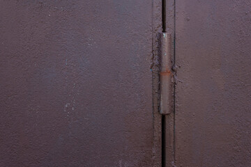Painted metal door hinges on the garage door