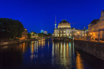 View from Ebert bridge in Berlin over river Spree and Bode museum to television tower in evening twillight in summer