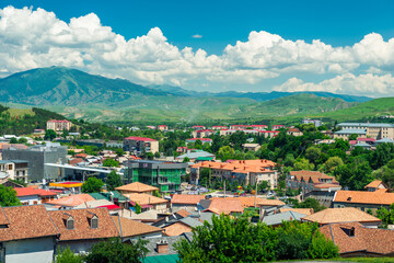 Fototapeta na wymiar Landscape of the city of Georgia against the backdrop of beautiful picturesque mountains on a sunny summer day