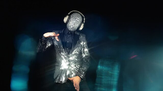 Mr disco ball wearing silver jacket dancing