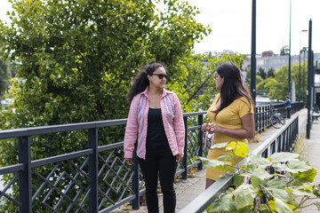 Naklejka premium couple of two women talking outdoors