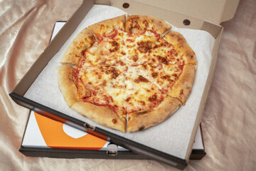 Pizza in an open delivery box. Home delivery
