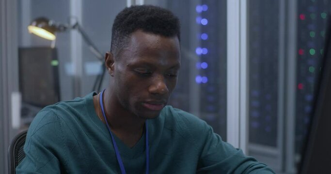 Tired young man working in data center