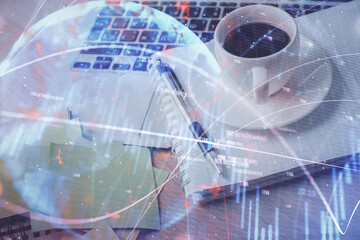 Double exposure of forex chart drawing and desktop with coffee and items on table background. Concept of financial market trading