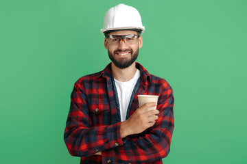 Bearded engineer or constructor man in plai shirt standing with paper cup of coffe or tea over...