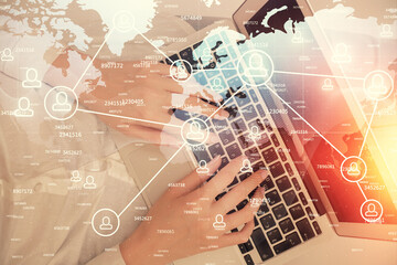 Fototapeta premium Double exposure of woman hands working on computer and social network theme hologram drawing. Top View. People connection concept.