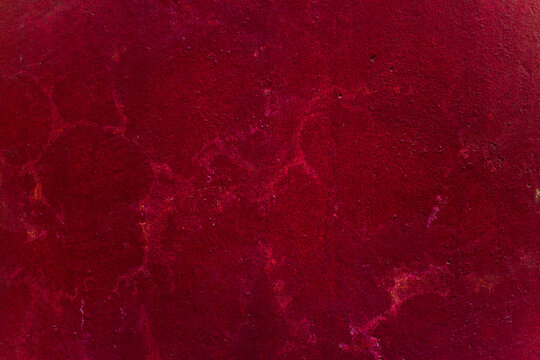 Old burgundy red textured wall, with cracks and stripes. Beautiful abstract background. High quality photo